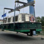 Vedette fluviale Jeanneau Eau Claire 930 Cassis (1985) – coque verte sortie de l'eau à la grue